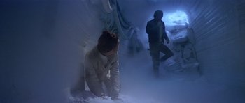 Movie still from “Star Wars: Episode V - The Empire Strikes Back” (1980), directed by Irvin Kershner – A man kneeling down next to another man; Wide shot, Low angle