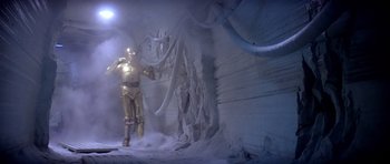 Movie still from “Star Wars: Episode V - The Empire Strikes Back” (1980), directed by Irvin Kershner – A man in a gold suit standing in the snow; Wide shot, Low angle