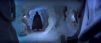 Movie still from “Star Wars: Episode V - The Empire Strikes Back” (1980), directed by Irvin Kershner – A darth vader in a cave in the snow; Wide shot, Low angle