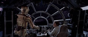 Movie still from “Star Wars: Episode V - The Empire Strikes Back” (1980), directed by Irvin Kershner – A woman sitting in a chair next to an iron man robot; Wide shot, Over the shoulder angle