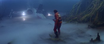 Movie still from “Star Wars: Episode V - The Empire Strikes Back” (1980), directed by Irvin Kershner – A man standing in the middle of the ocean looking at an airplane wreck; Wide shot, Low angle