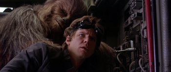 Movie still from “Star Wars: Episode V - The Empire Strikes Back” (1980), directed by Irvin Kershner – A person wearing goggles with a chewbacca behind him; Close Up shot, Low angle