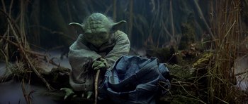 Movie still from “Star Wars: Episode V - The Empire Strikes Back” (1980), directed by Irvin Kershner – An image of a star wars character sitting on the ground; Medium shot, Low angle