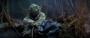 Movie still from “Star Wars: Episode V - The Empire Strikes Back” (1980), directed by Irvin Kershner – An image of a man that is dressed like yoda; Medium shot, Low angle