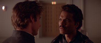 Movie still from “Star Wars: Episode V - The Empire Strikes Back” (1980), directed by Irvin Kershner – Two men talking to each other in a dark room; Close Up shot, Over the shoulder angle