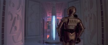 Movie still from “Star Wars: Episode V - The Empire Strikes Back” (1980), directed by Irvin Kershner – A man in a metallic suit standing in front of a building; Extreme Wide shot, Low angle
