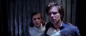 Movie still from “Star Wars: Episode V - The Empire Strikes Back” (1980), directed by Irvin Kershner – A man and a woman standing next to each other in front of a wall; Close Up shot, Low angle