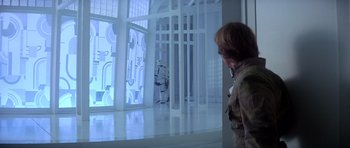 Movie still from “Star Wars: Episode V - The Empire Strikes Back” (1980), directed by Irvin Kershner – A man standing in front of a screen with a robot; Wide shot, Over the shoulder angle