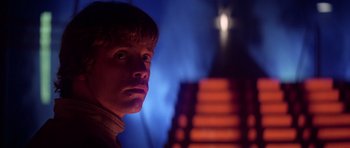 Movie still from “Star Wars: Episode V - The Empire Strikes Back” (1980), directed by Irvin Kershner – A young man stares into the distance in front of a staircase; Close Up shot, Low angle