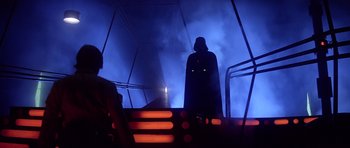 Movie still from “Star Wars: Episode V - The Empire Strikes Back” (1980), directed by Irvin Kershner – Darth vader standing on the stairs in a dark room; Wide shot, Low angle