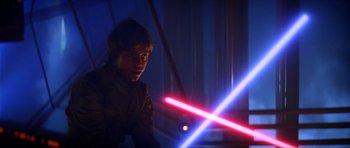 Movie still from “Star Wars: Episode V - The Empire Strikes Back” (1980), directed by Irvin Kershner – A young man is holding a light saber in his hand; Close Up shot, Over the shoulder angle