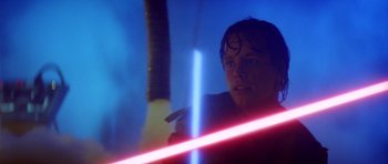 Movie still from “Star Wars: Episode V - The Empire Strikes Back” (1980), directed by Irvin Kershner – A man is holding a light saber in a room; Close Up shot, Low angle