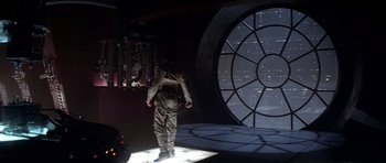 Movie still from “Star Wars: Episode V - The Empire Strikes Back” (1980), directed by Irvin Kershner – A man in a costume standing in front of a screen; Wide shot, Low angle