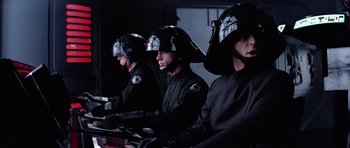 Movie still from “Star Wars: Episode VI - Return of the Jedi” (1983), directed by Richard Marquand – A group of people in black uniforms and helmets; Medium shot, Over the shoulder angle