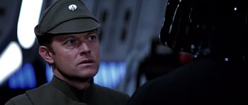 Movie still from “Star Wars: Episode VI - Return of the Jedi” (1983), directed by Richard Marquand – A person wearing a uniform; Close Up shot, Over the shoulder angle