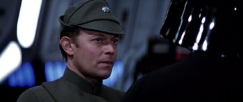 Movie still from “Star Wars: Episode VI - Return of the Jedi” (1983), directed by Richard Marquand – A person wearing a hat; Close Up shot, Over the shoulder angle