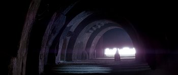 Movie still from “Star Wars: Episode VI - Return of the Jedi” (1983), directed by Richard Marquand – A person standing in a dark room with light coming from the window; Extreme Wide shot, Low angle