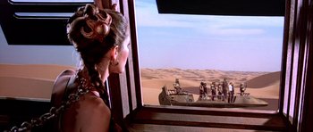 Movie still from “Star Wars: Episode VI - Return of the Jedi” (1983), directed by Richard Marquand – A woman looking out of a window at the desert; Wide shot, Over the shoulder angle