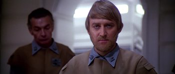 Movie still from “Star Wars: Episode VI - Return of the Jedi” (1983), directed by Richard Marquand – A person wearing a shirt and a jacket; Close Up shot, Low angle