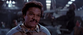 Movie still from “Star Wars: Episode VI - Return of the Jedi” (1983), directed by Richard Marquand – A person with a mustache; Close Up shot, Over the shoulder angle