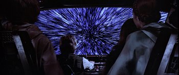 Movie still from “Star Wars: Episode VI - Return of the Jedi” (1983), directed by Richard Marquand – A person sitting in front of a large screen; Medium shot, Over the shoulder angle