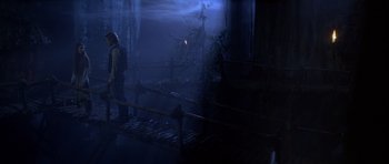 Movie still from “Star Wars: Episode VI - Return of the Jedi” (1983), directed by Richard Marquand – A man standing on a bridge in a dark room; Wide shot, Over the shoulder angle