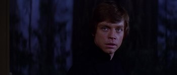 Movie still from “Star Wars: Episode VI - Return of the Jedi” (1983), directed by Richard Marquand – A man in a black shirt is looking at the camera; Close Up shot, Low angle