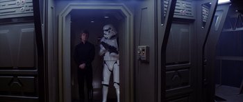 Movie still from “Star Wars: Episode VI - Return of the Jedi” (1983), directed by Richard Marquand – A man standing next to a stormtrooper; Wide shot, Low angle