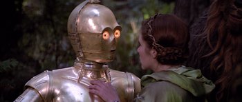 Movie still from “Star Wars: Episode VI - Return of the Jedi” (1983), directed by Richard Marquand – A woman standing next to a large metal robot; Close Up shot, Over the shoulder angle