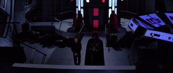 Movie still from “Star Wars: Episode VI - Return of the Jedi” (1983), directed by Richard Marquand – A man in a black suit and darth vader costume; Wide shot, Low angle