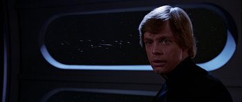 Movie still from “Star Wars: Episode VI - Return of the Jedi” (1983), directed by Richard Marquand – A man in a black shirt is looking into the distance; Close Up shot, Low angle