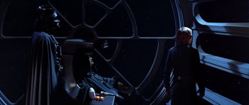 Movie still from “Star Wars: Episode VI - Return of the Jedi” (1983), directed by Richard Marquand – A man sitting in front of a window at night; Medium shot, Over the shoulder angle