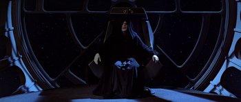 Movie still from “Star Wars: Episode VI - Return of the Jedi” (1983), directed by Richard Marquand – An emperor palpatine sitting in a chair in the dark; Wide shot, High angle