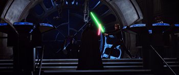 Movie still from “Star Wars: Episode VI - Return of the Jedi” (1983), directed by Richard Marquand – A man in a black robe holding a green and red lightsaber in front of another man; Wide shot, Overhead angle