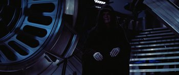 Movie still from “Star Wars: Episode VI - Return of the Jedi” (1983), directed by Richard Marquand – A person in a black robe and a hood; Medium shot, Low angle