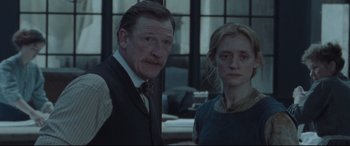 Movie still from “Suffragette” (2015), directed by Sarah Gavron – A man and a woman standing next to each other; Medium shot, Low angle