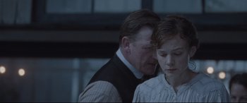 Movie still from “Suffragette” (2015), directed by Sarah Gavron – A man and a woman standing next to each other; Close Up shot, Over the shoulder angle