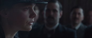Movie still from “Suffragette” (2015), directed by Sarah Gavron – A woman wearing a hat looking at a man; Close Up shot, Over the shoulder angle
