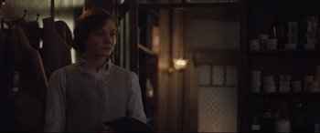 Movie still from “Suffragette” (2015), directed by Sarah Gavron – A woman standing in front of a door; Medium shot, Over the shoulder angle