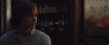 Movie still from “Suffragette” (2015), directed by Sarah Gavron – A young woman in a white shirt is looking to her left; Close Up shot, Over the shoulder angle