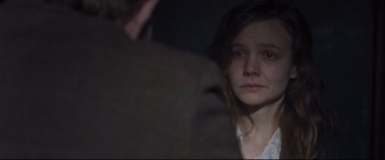 Movie still from “Suffragette” (2015), directed by Sarah Gavron – A young woman looking into a mirror while standing next to a man; Close Up shot, Over the shoulder angle
