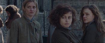 Movie still from “Suffragette” (2015), directed by Sarah Gavron – Two women standing next to each other in front of a building; Close Up shot, Over the shoulder angle