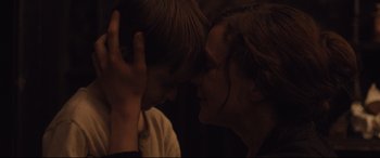 Movie still from “Suffragette” (2015), directed by Sarah Gavron – A woman and a young boy are touching heads together; Close Up shot, Over the shoulder angle