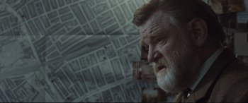 Movie still from “Suffragette” (2015), directed by Sarah Gavron – An old man with a beard looking at the camera; Close Up shot, Over the shoulder angle