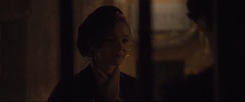 Movie still from “Suffragette” (2015), directed by Sarah Gavron – A young woman is looking out of a window at night; Close Up shot, Over the shoulder angle