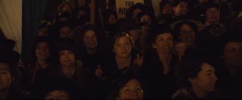 Movie still from “Suffragette” (2015), directed by Sarah Gavron – A group of people sitting in a dark room; Medium shot, High angle