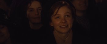 Movie still from “Suffragette” (2015), directed by Sarah Gavron – A woman smiling at the camera with another woman in the background; Close Up shot, Over the shoulder angle