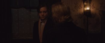 Movie still from “Suffragette” (2015), directed by Sarah Gavron – A young woman is looking at the reflection of herself in a mirror; Medium shot, Over the shoulder angle