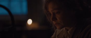 Movie still from “Suffragette” (2015), directed by Sarah Gavron – A woman with long hair is looking down at her face; Close Up shot, Over the shoulder angle