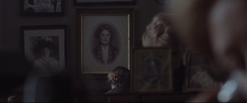 Movie still from “Suffragette” (2015), directed by Sarah Gavron – A woman sitting in front of a picture of a woman; Extreme Close Up shot, Over the shoulder angle